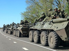 Russian servicemen drive armoured personnel carriers on the outskirts of the city of Belgorod near the Russian-Ukrainian border, April 25, 2014. (REUTERS/Alexander Mikhailov)