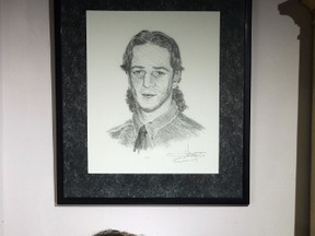 Shirley Hickman is a 2007 recipient of a Women of Excellence award. Above her is a portrait of her son, Tim, who was killed on the job in 1996. (Free Press file photo)