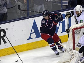 Columbus Blue Jackets Cam Atkinson (13) fights for possession with Pittsburgh Penguins Rob Scuderi (4) during the second period in game four of the first round of the 2014 Stanley Cup Playoffs at Nationwide Arena.  (Rob Leifheit-USA TODAY Sports)