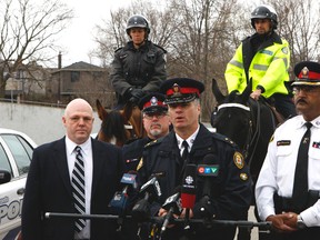 Toronto Police officers flooded an upscale neighbourhood near Lawrence Ave. W. and Avenue Rd. on Saturday warning residents about an abundance of break-ins and car thefts in the area in recent months. Insp. Tim Crone, of 32 Division, is surrounded by fellow officers as he updated the media on the awareness effort. CHRIS DOUCETTE/TORONTO SUN