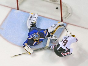 Chicago Blackhawks centre Jonathan Toews scores the overtime winner against St. Louis Blues’ Ryan Miller on Friday night. (USA TODAY SPORTS)