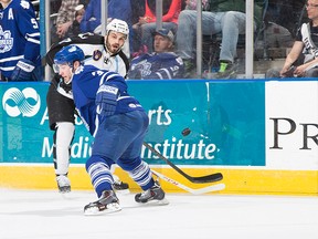 Admirals’ Michael Liambas braces for a hit from the Marlies’ T.J. Brennan in Milwaukee last night. The Marlies won 5-2. (Scott Paulus/Milwaukee Admirals)