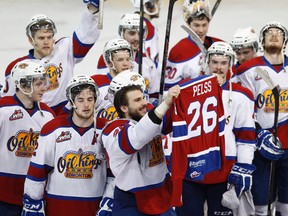 Edmonton forward Mitchell Moroz (29) holds up former teammate Kristians Pelss' jersey after the team beat the Medicine Hat Tigers at Rexall Place in Edmonton, Alta., on Saturday, April 26, 2014. Pelss, who died in Latvia in 2013, was in the minds of fellow players as they played the 2013-14 season. The Oil Kings won 4-3, winning the WHL Eastern Conference trophy. Ian Kucerak/Edmonton Sun/QMI Agency