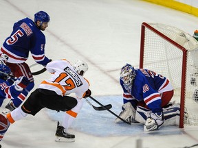 New York Rangers goalie Henrik Lundqvist (30) makes a save on Philadelphia Flyers right wing Wayne Simmonds (17) in the 2nd period of game five of the first round of the 2014 Stanley Cup Playoffs at Madison Square Garden.  John Geliebter-USA TODAY Sports