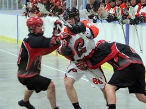 Point Edward Pacers forward Connor Smith (in white) tries to find his way between a pair of Wallaceburg Red Devils defenders in the 2nd period of their OLA Jr. B Lacrosse game on Sunday, April 27. The game was Point Edward's season and home opener, and despite five goals from Smith, they fell 11-8. SHAUN BISSON/THE OBSERVER/QMI AGENCY
