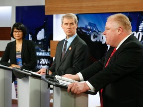 Mayor Rob Ford (right) speaks as candidates Olivia Chow (left) and David Socknacki listen during a Toronto mayoral election debate in Toronto, March 26, 2014. (REUTERS/Mark Blinch)
