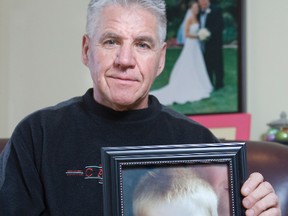 Bob Facca holds a photo of his four-year-old grandson, Louie Facca, who has been diagnosed with Duchenne muscular dystrophy. (DEREK RUTTAN/ The London Free Press)