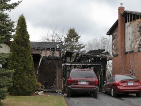 The damage can be seen clearly the day after a fire broke out at 817 Mona Dr., on Saturday. The fire destroyed the garage and two cars in the driveway, as well as causing damage to the neighbouring house. Julia McKay/The Whig-Standard