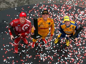 Ryan Hunter-Reay (centre) driver of the #28 Andretti Autosport Dallara Honda, celebrates winning the Honda Indy Car Grand Prix of Alabama with third-place finisher Scott Dixon (right) and second-place finisher Marco Andretti in Birmingham, Ala., yesterday. (AFP)