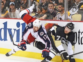 Jackets’ Brandon Dubinsky, taking Paul Martin hard into the boards during an earlier game in this series with Pittsburgh, feels the fact that his team has made things closer than most expected is putting more pressure on the Penguins. (AFP)