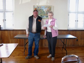 On behalf of Dungannon's local buseinss owners, George Smyth presents a cheque to Iren Markham, treasurer of Dungannon Seniors to purchase tables. April  24, 2014.