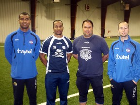 Four members of the Thunder Bay Chill soccer team at the indoor field at the new Sportsplex after hosting two days of skills training camps for local players.