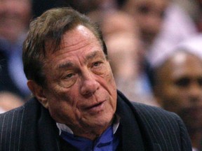 Los Angeles Clippers owner Donald Sterling sits on the sidelines wathcing his team play the New York Knicks in their NBA basketball game in Los Angeles in this February 11, 2009 file photo. (REUTERS/Lucy Nicholson/Files)