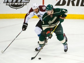 Wild right wing Charlie Coyle (3) controls the puck past Avalanche defenceman Ryan Wilson (44) during NHL playoff action in St. Paul, Minn., on Thursday, Apr. 24, 2014. (Marilyn Indahl/USA TODAY Sports)