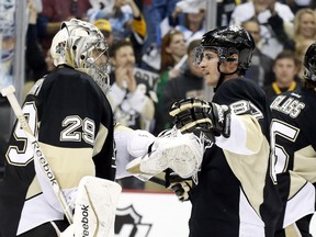 Pittsburgh Penguins goalie Marc-Andre Fleury (29) and center Sidney Crosby (87) celebrate after defeating the Columbus Blue Jackets in game five of the first round of the 2014 Stanley Cup Playoffs at the CONSOL Energy Center on Apr 26, 2014 in Pittsburgh, PA, USA. (Charles LeClaire/USA TODAY Sports)