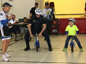 BRUCE BELL/THE INTELLIGENCER
Prince Edward OPP Const. Anthony Mann challenges Brandon, a Massassaga-Rednersville Public School student, to a race during the Pedal for Hope Quinte kickoff Monday morning.