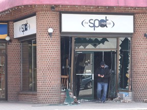 A man walks out of The Spot Nightclub on Monday morning after a car smashed through the front entrance. 
IAN MACALPINE/KINGSTON WHIG-STANDARD/QMI AGENCY