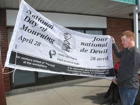Jason Patterson, a miner from Sudbury, was a guest at Monday morning's National Day of Mourning ceremony and flag-raising at the steelworkers union centre off Montreal Street to honour workers who died or were injured in the workplace. Kingston, Ont. Monday.
MICHAEL LEA\THE WHIG STANDARD\QMI AGENCY