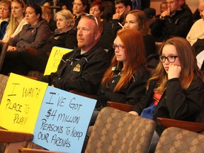 Bryan Meere, Samantha Meere and Macey Leppington, of Sarnia Girls Hockey, listen in on a special city council meeting Monday, April 28, 2014. Council voted narrowly in favour of keeping Germain Arena open and finalizing negotiations with Lambton College to sell off the second RBC rink. BARBARA SIMPSON/THE OBSERVER/QMI AGENCY