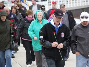 More than 200 people marched from the Bayshore Park flag court to the fenced off Missing Worker Memorial at Centennial Park Monday during Sarnia's Day of Mourning event. The annual memorial is in honour of workers injured or killed on the job, or affected by occupational disease. TYLER KULA/ THE OBSERVER/ QMI AGENCY