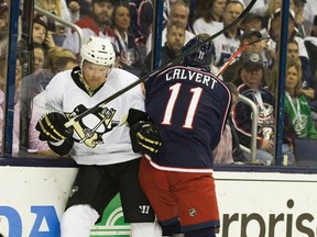 Columbus Blue Jackets left wing Matt Calvert (11) hits Pittsburgh Penguins defenceman Paul Martin (7) in Game 6 of the first round of the 2014 Stanley Cup Playoffs at Nationwide Arena. (Greg Bartram-USA TODAY Sports)