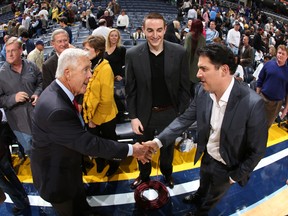 Michael Heisley, former majority owner of the Memphis Grizzlies, left, talks to Robert Pera, the team's chairman, centre, and Jason Levien, the team's chief executive officer, after a game against the Utah Jazz on November 5, 2012 at FedExForum in Memphis, Tennessee. (Joe Murphy/NBAE via Getty Images/AFP)