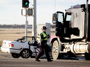 Police investigate at the scene of a fatal collision on Kingsway at the Princess Elizabeth Avenue intersection, in Edmonton on Monday. (DAVID BLOOM/Edmonton Sun)