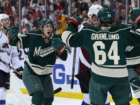 Minnesota Wild forward Mikael Granlund (64) celebrates his goal with forward Zach Parise (11) during the first period against the Colorado Avalanche in Game 6 of the first round of the 2014 Stanley Cup Playoffs at Xcel Energy Center. (Brace Hemmelgarn-USA TODAY Sports)