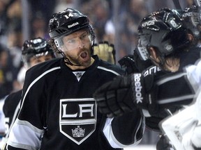 Justin Williams #14 of the Los Angeles Kings celebrates with his team on the bench after scoring his goal to take a 2-1 lead during the third period in Game 6 of the first =round of the 2014 NHL Stanley Cup Playoffs at Staples Center on April 28, 2014 in Los Angeles, California. (Harry How/Getty Images/AFP)
