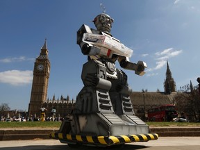 A robot is pictured in front of the Houses of Parliament and Westminster Abbey as part of the Campaign to Stop Killer Robots in London April 23, 2013. REUTERS/Luke MacGregor