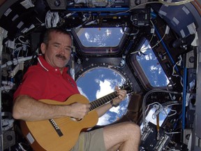 Chris Hadfield plays Christmas carols while floating over the Mediterranean on Dec. 25 aboard the International Space Station. Hadfield will be among other notable local residents taking part in upcoming celebrations for Sarnia's centennial. SUBMITTED