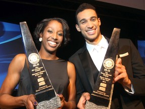 Justine Colley of Saint Mary's and Philip Scrubb of Carleton hold their trophies Monday night in Calgary after being named the top university athletes in Canada. Darren Makowichuk/QMI Agency