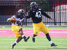 Former NFL free safety David Caldwell (left, 42) is trying out as a linebacker with the Tiger-Cats during mini-camp this week in The Hammer. (DAVE ABEL/Toronto Sun)