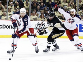 Columbus Blue Jackets defenceman Jack Johnson (left) handles the puck against pressure from Pittsburgh Penguins left wing James Neal during Game 1 of their Eastern Conference quarterfinal series at the Consol Energy Center in Pittsburgh, April 16, 2014. (CHARLES LeCLAIRE/USA Today)