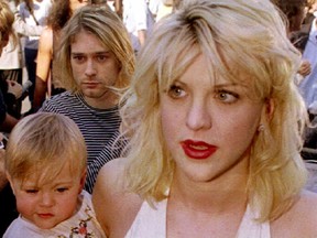 Kurt Cobain arrives with wife Courtney Love, holding their daughter Frances Bean Cobain, for the MTV Music Awards show in Los Angeles in this September 9 1992, file photo. (REUTERS/Fred Prouser/Files)