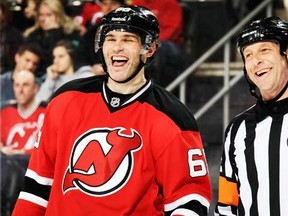 Jaromir Jagr #68 of the New Jersey Devils shares a laugh with referee Brad Meier #34 during a game against the New York Islanders at the Prudential Center on April 11, 2014 in Newark, New Jersey. (Bruce Bennett/Getty Images/AFP)