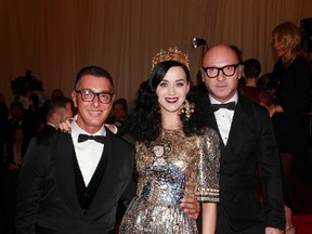 Designers Domenico Dolce (L) and Stefano Gabbana and singer Katy Perry arrive at the Metropolitan Museum of Art Costume Institute Benefit celebrating the opening of "PUNK: Chaos to Couture" in New York, May 6, 2013.  REUTERS/Carlo Allegri
