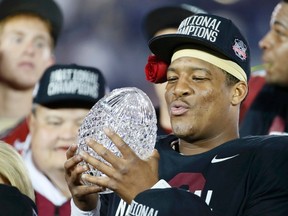 Florida Seminoles quarterback Jameis Winston holds the championship trophy after they defeated the Auburn Tigers to win the BCS Championship football game in Pasadena, California January 6, 2014.    REUTERS/Lucy Nicholson