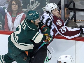 Minnesota Wild forward Nino Niederreiter (22) hits Colorado Avalanche forward Nathan MacKinnon (29) during the second period in Game 6 of the first round of the 2014 Stanley Cup Playoffs at Xcel Energy Center. (Brace Hemmelgarn-USA TODAY Sports)