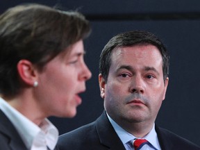 Minister of Citizenship, Immigration and Multiculturalism Jason Kenney listens to MP Kellie Leitch as she speaks to the media in Ottawa in this April 29, 2013 file photo. (Andre Forget/QMI Agency)