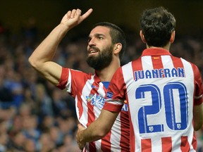 Atletico Madrid's Arda Turan (L) celebrates his goal against Chelsea with teammate Juanfran (R) during their Champions League semifinal second leg soccer match at Stamford Bridge stadium in London April 30, 2014. (REUTERS)
