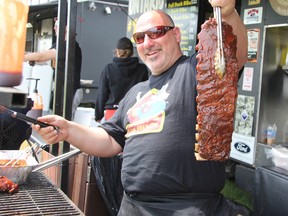 Peter Giannopoulos of Crabby's BBQ Shack shows off his BBQ-ing technique at Sarnia's Ribfest on Saturday.
LIZ BERNIER/THE OBSERVER/QMI AGENCY
