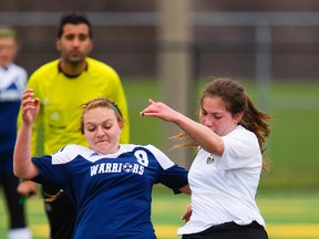 Daria Ciupek of Woodstock St. Mary?s fights for possession with Holy Cross?s Jessica Vieira during their TVRA London District Conference girls? soccer game at the City Wide fields on Wednesday. The Strathroy school won 3-0 on a hat trick by Vieira. (Mike Hensen/The London Free Press)