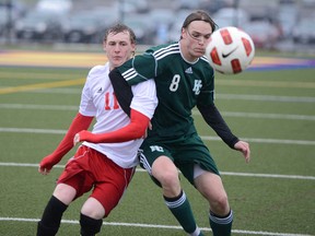 Nick Gallagher, right, of Holy Cross collides with Curtis Reilly of Sydenham during a Kingston Area senior boys soccer game at Queen’s University's West Campus on Wednesday. (Justin Greaves/For The Whig-Standard)