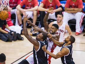 Raptors' Amir Johnson and Brooklyn Nets' Andray Blatche get nasty under the rim at the ACC last night. (Ernets Doroszuk/Toronto Sun)