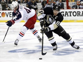 Pittsburgh Penguins centre Sidney Crosby (87) skates with the puck around Columbus Blue Jackets centre Artem Anisimov (42) during the first period in Game 2 of the first round of the 2014 Stanley Cup Playoffs at the CONSOL Energy Center. (Charles LeClaire-USA TODAY Sports)