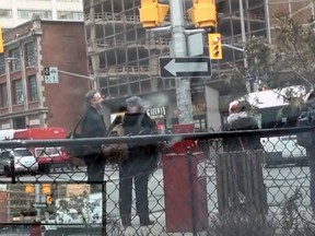 A frame grab from a video which allegedly shows numerous OC Transpo buses running red lights at a downtown Ottawa intersection. (YouTube screen grab)
