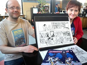 Siblings and business partners A. Jaye and Alison Williams of Sill Will Studios sit next to art from their comic series The Adventures of Astrodog — which has recently enjoyed a physical release — in London, Ont. May 1, 2014. CHRIS MONTANINI\LONDONER\QMI AGENCY