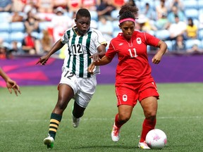 Winnipeg's Desiree Scott will play in the Canada-U.S. friendly May 8. She's shown here fighting for the ball against South Africa's Portia Modise during the 2012 London Olympics. (REUTERS)