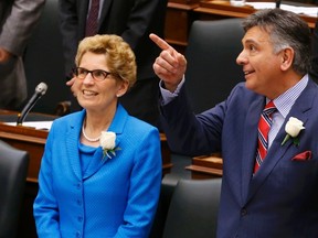 Ontario Finance Minister Charles Sousa (R) and Ontario Premier Kathleen Wynne stand in the chamber before the delivery of the provincial budget at Queen's Park in Toronto, May 1, 2014. REUTERS/Mark Blinch